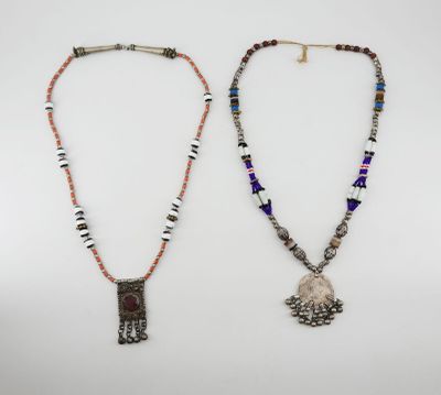 two necklaces, one with a pendant and the other with beads