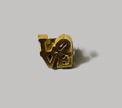 gold plated love ring with a heart and the word love in the middle