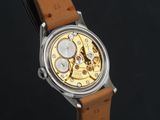 a close up of a watch with a brown leather strap