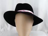black wide brimmed fedora hat with pink ribbon