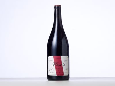 a bottle of red wine sitting on top of a table