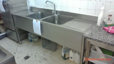a kitchen with a sink and a refrigerator in it