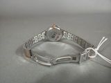 silver bracelet with a silver watch on a silver surface