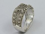 a close up of a silver ring on a white surface