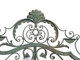 a metal gate that has a scroll design on it