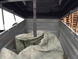 a truck with a lot of bags in the back of it