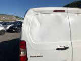 a white van parked in a parking lot with other cars