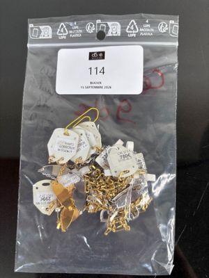 a bag of gold and silver paper clips on a table