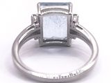 a close up of a ring with a blue topaz stone