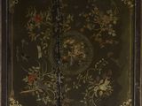 an antique black and gold painted cabinet with flowers and birds