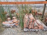 a pile of clay pots sitting on top of a wooden pallet