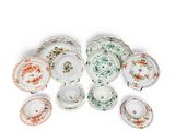a group of porcelain dishes and cups on a white surface