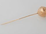 an image of a rose gold lapel pin on a white background