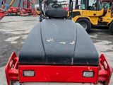 a close up of a road roller in a parking lot