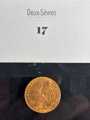 a close up of a gold coin on a black surface