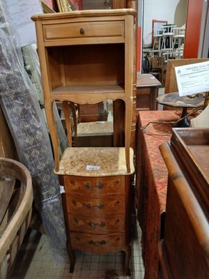 a tall wooden cabinet with a drawer on top of it