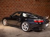a picture of a black sports car parked in a garage