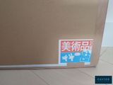 a cardboard box with a sticker on it sitting on the floor