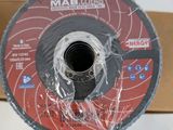a close up of a metal grinding disc on a cardboard box