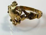 an image of a gold ring with a frog on it