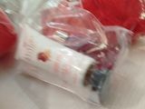 two red gloves and a tube of toothpaste on a table