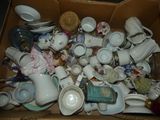 a box full of tea cups and saucers in it