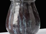 a close up of a vase on a table