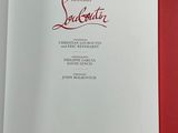 an open book on a table with a red cover and white pages