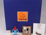 figurines of tintin figures sitting on top of a blue box