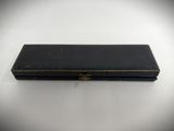 an old black box sitting on top of a white table