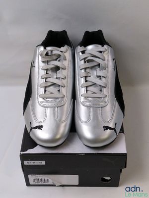 a close up of a pair of silver shoes on a box