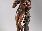 an image of a bronze statue of a woman holding a flower