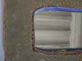 a picture of a mirror that is hanging on the wall