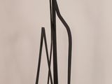 a metal sculpture that is standing on a table