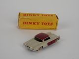 dinky toy car and box of dinky toys on a white surface