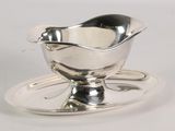 a silver plate with a saucer and a spoon on it
