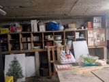 a wooden table in the middle of a room with a lot of items on it