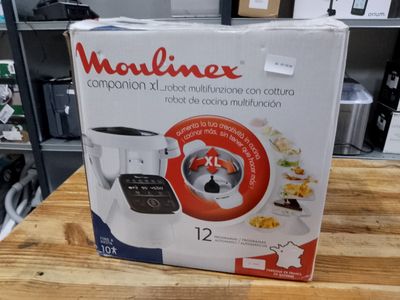 the box of a food processor sits on a table in a store
