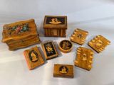 several small wooden boxes with pictures of people and flowers on them