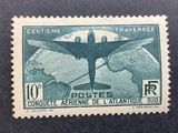 an old postage stamp with a plane flying over a mountain range