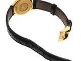 a close up of a watch on a black strap on a white background