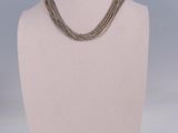 a close up of a mannequin with a necklace on it