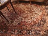 a rug on the floor in a room with a table and chairs