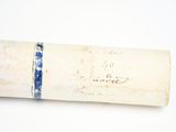 a roll of paper with writing on it sitting on a table
