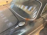 an old car that is sitting in the garage