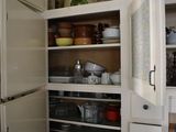 an image of a kitchen with white cabinets and a refrigerator