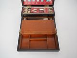 a small wooden box that has a lot of items inside of it