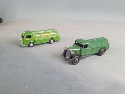 two toy trucks that are sitting next to each other