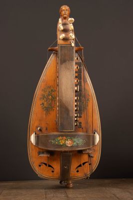 an old musical instrument with a wooden body on a wooden table