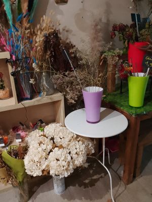 a small table with a vase of flowers on top of it